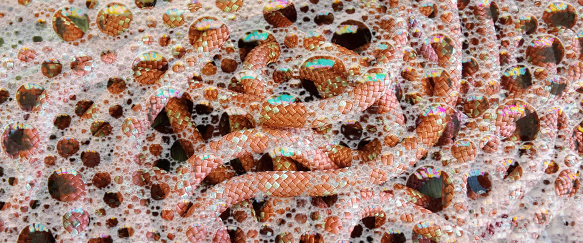 An orange rope covered in soap suds.