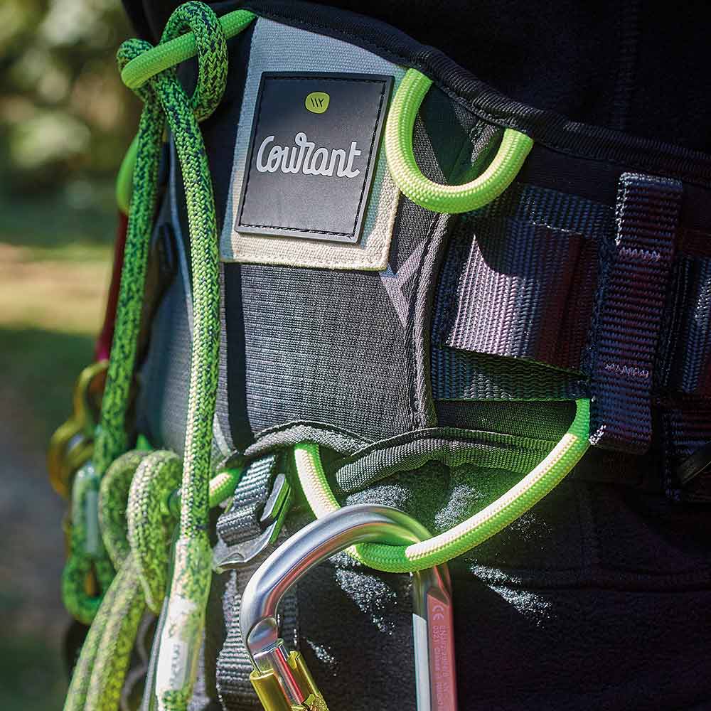 Close-up of Courant's Koala V1.2 harness in black and green with snap hook and rope ends