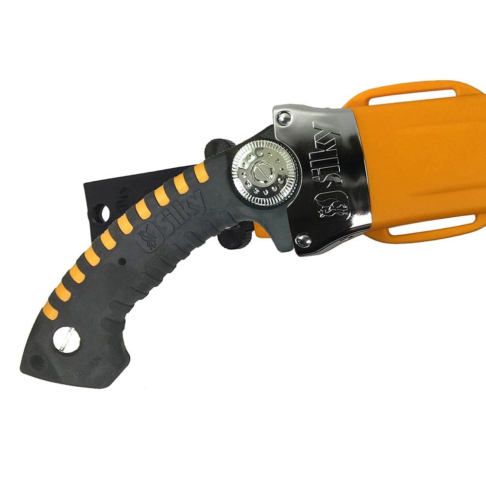 Close-up of the black handle with yellow accents and silver adjustment wheel of the Silky Sugoi 420-6.5-5.5 hand saw, partially orange sheath visible