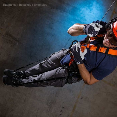 Relief Straps, Person in Safety Helmet and Gloves Wearing Orange Seat Belt While Abseiling in Dark Environment
