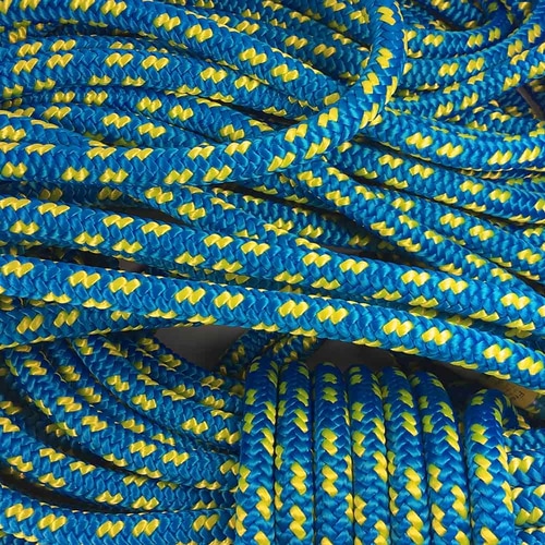 Several blue and yellow XP-e Aruba ropes lie loose and coiled on top of each other