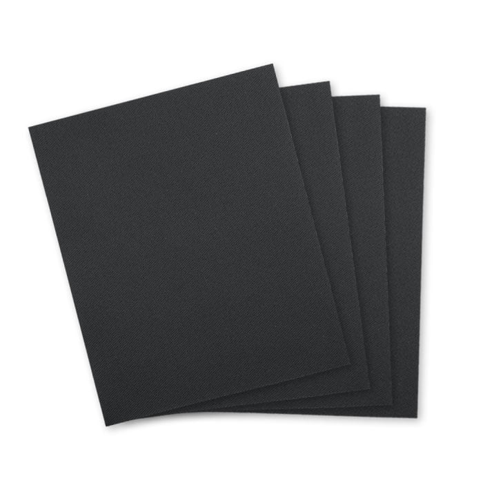 Patch fabric in black, four square pieces of fabric lying on top of each other