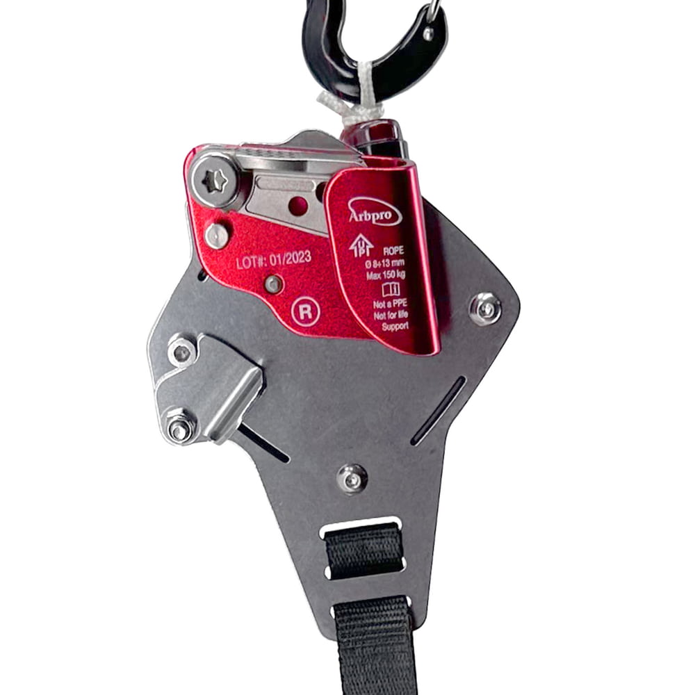 Close-up of Gemini Knee belay device with red metal part, black carabiner and black strap