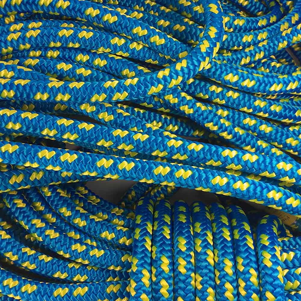 Several blue and yellow XP-e Aruba ropes lie loose and coiled on top of each other