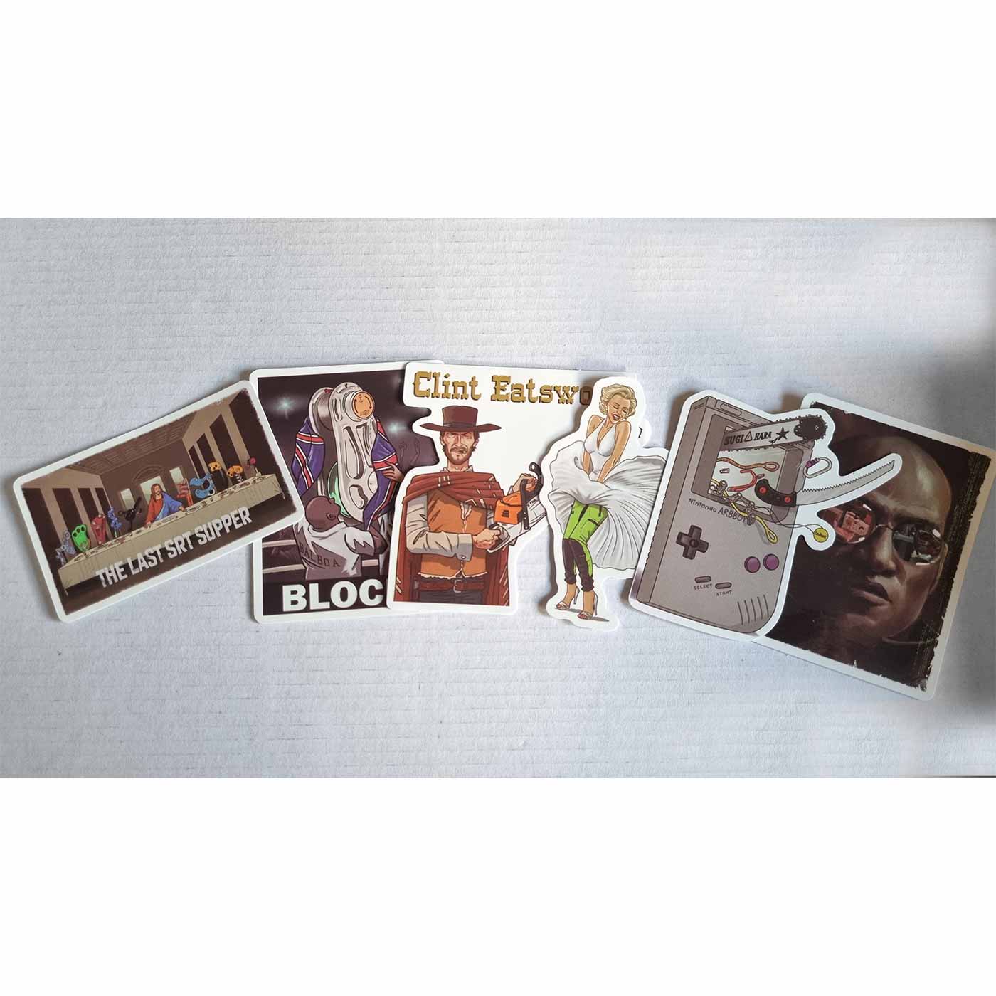 Six individual stickers from the ARB Fiction Pack Vol. 2, including "THE LAST SRT SUPPER" with figures at a table, "BLOCKY" with a figure in a white robe, Clint Eatswood with a chainsaw, woman in a white dress and green pants, Gameboy-like device with cha