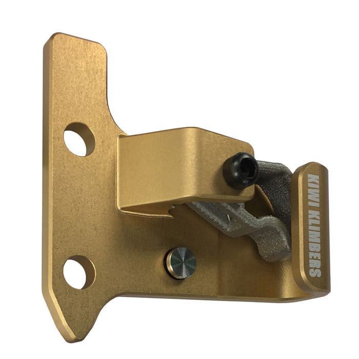 SpikeSender 2 R, gold-coloured metal part with two drill holes and black screw, on the front is written "KIWI KLIMBERS"