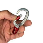 XSRE Swivel Lock snap hook in silver with red twist lock and red swivel, held in one hand