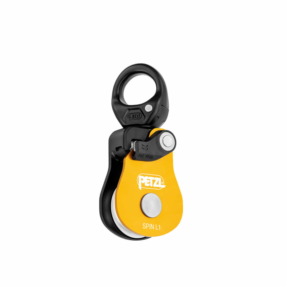 Petzl Spin L1 yellow and black pulley with white Petzl logo and Spin L1 lettering on the front