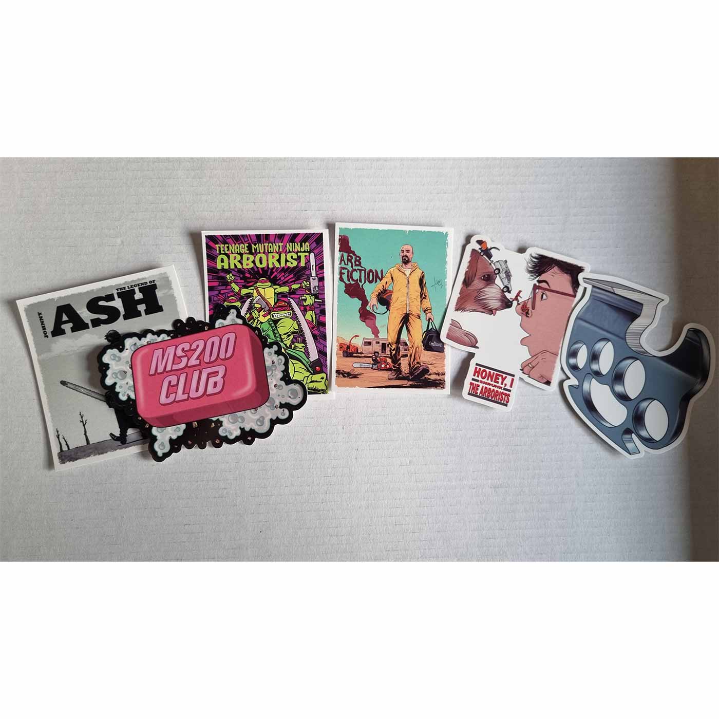 ARB Fiction Pack Vol. 5 stickers with six different designs, including a person in yellow jumpsuits, a dog and a human, a pink bar of soap that says "MS200 CLUB", a metal handle, a man with a chainsaw, and cartoon characters that say "TEENAGE MUTANT NINJA