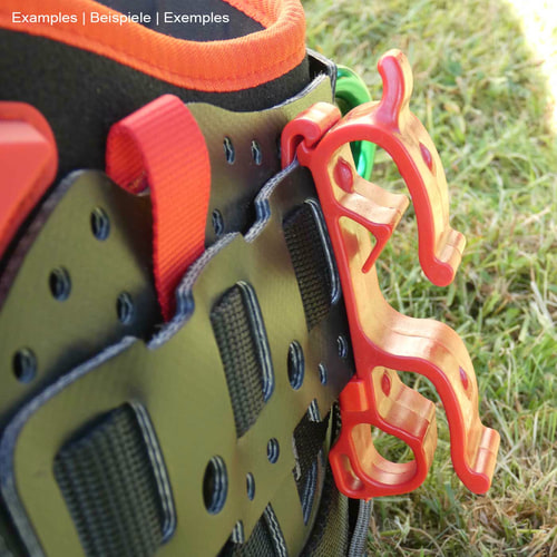 Buddy red plastic clip on black climbing harness with orange edge and red loops