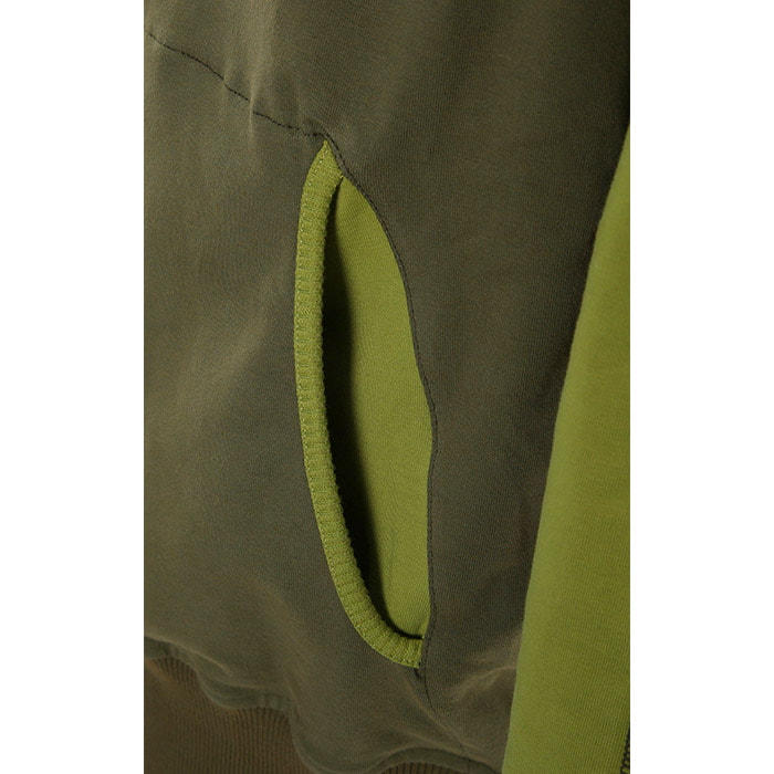 Close-up of the front pocket of the Forest WoodU hoodie in two shades of green