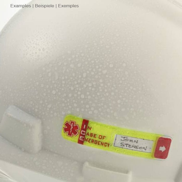 Vital ID Emergency ID yellow with red arrow and text "IN CASE OF EMERGENCY" with handwritten name "John Stenson" on a white helmet with water droplets, manufacturer Vital ID