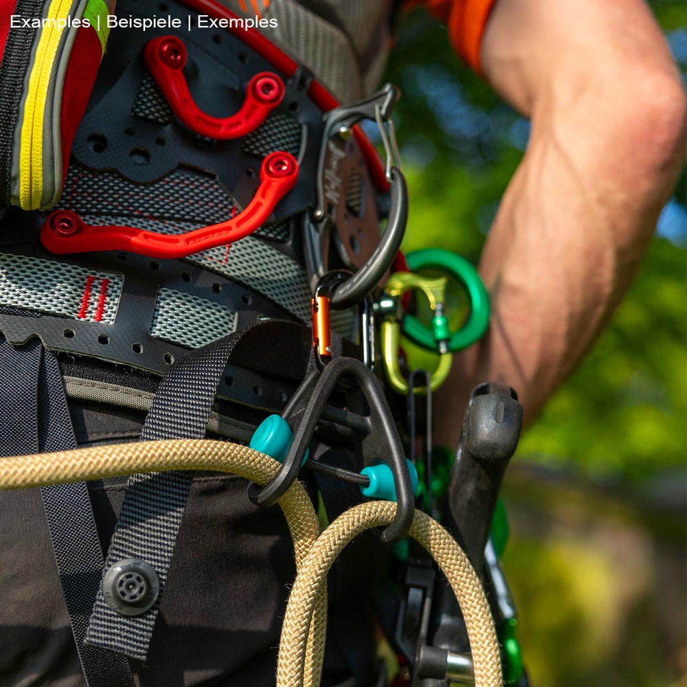 Sidekick product in black with two turquoise buttons, attached to a climbing harness with beige and yellow climbing line