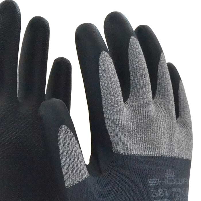 Close-up of the Showa 381 work gloves, focus on the gray fabric back and black fingertips with visible manufacturer name and model number.