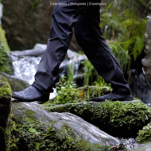 Skinner's gray sock with black sole on a foot standing on a moss-covered stone in nature