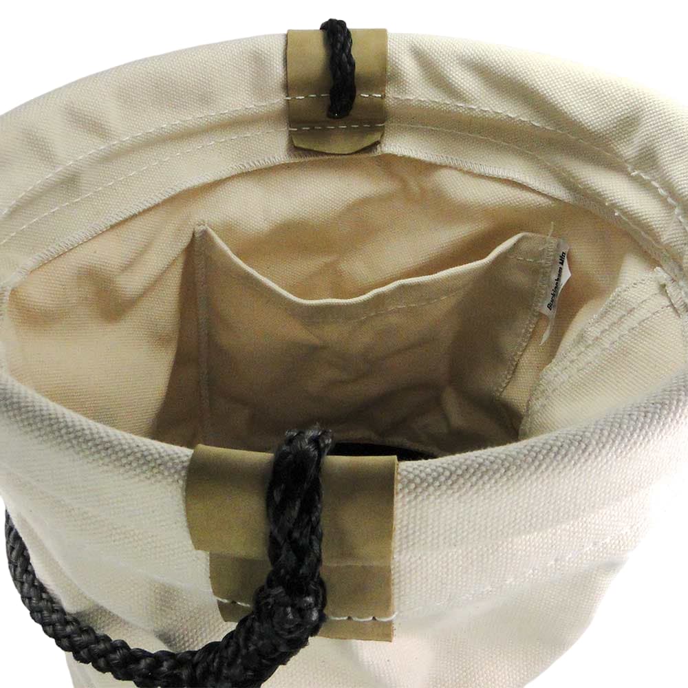 Material Bucket, interior view of the white fabric container with small compartment and black handle closure