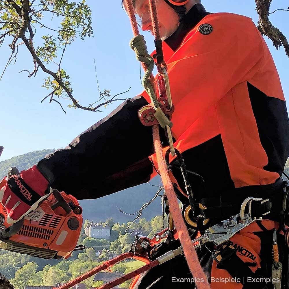 Person wearing Herma jacket by Francital in orange and black while working with climbing equipment and chainsaw