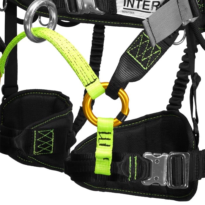 Treewor C Close-up of the black and green harness with orange carabiners and white labels with the lettering "INTER"