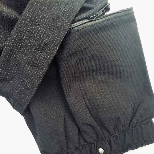 Close-up of Hermes trousers with zipper and elastic cuff in black
