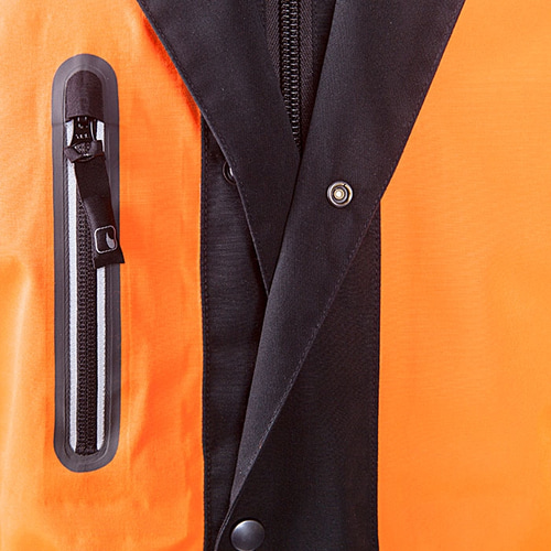 Close-up of the chest pocket with zipper and the black snap button placket of the Keiu rain jacket