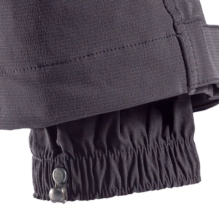 SIP climbing pants, close-up of the trouser leg hem with elastic waistband and two metal buttons for closure