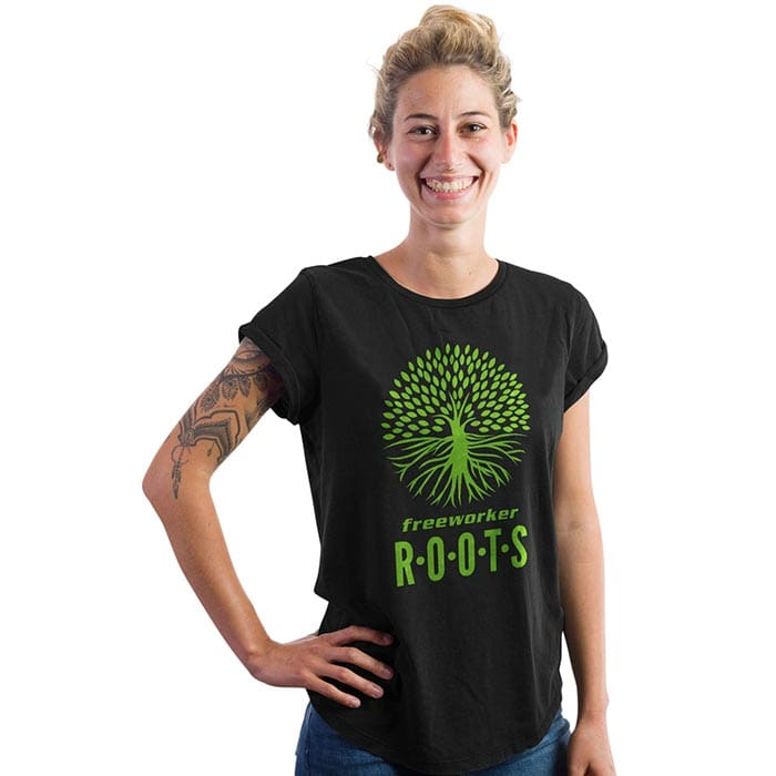 Woman wearing black T-shirt with green tree logo and lettering "freeworker ROOTS", product name Roots Pure Women