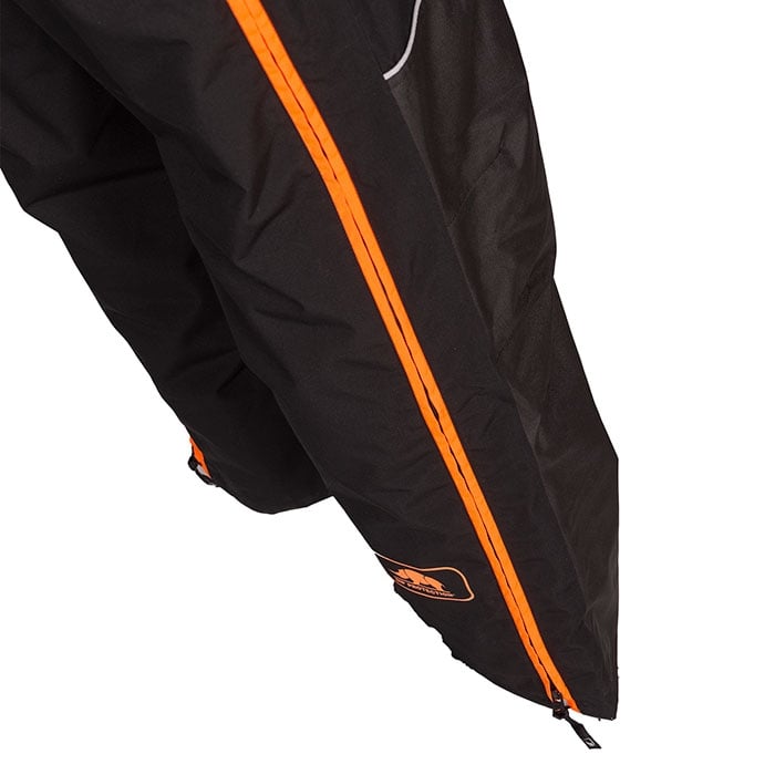 Detail of the lower leg of the Keiu rain pants with orange zipper and logo