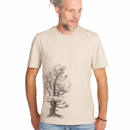 Man wearing Stone Pine Tree T-shirt in beige with black tree design, looking to the right