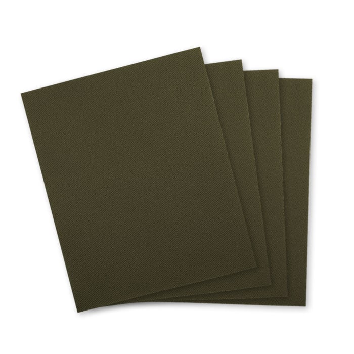 Patch fabric in dark green, four square pieces of fabric lying on top of each other