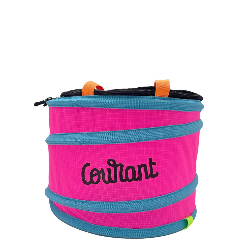 Pelican M, pink round container with blue edges and orange carrying loops, the word "Courant" in black lettering on the front