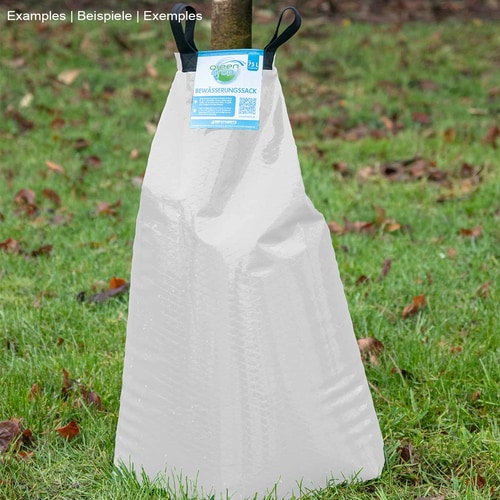 Greendrop White Watering Bag in White stands on green grass, with two black carrying loops and blue label at the top center, surrounded by autumnal leaves on the ground