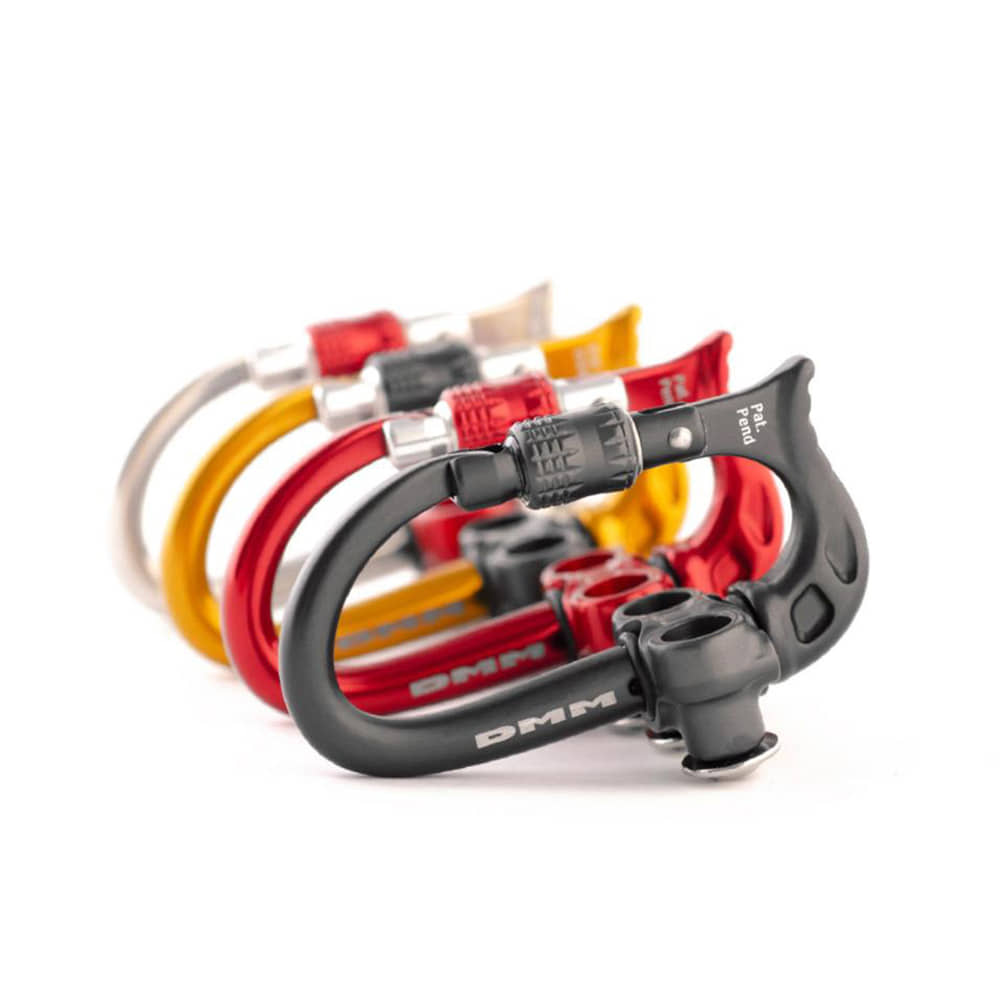 Micro Vault from DMM, four carabiners in the colors black, red, yellow and silver arranged next to each other with screw cap
