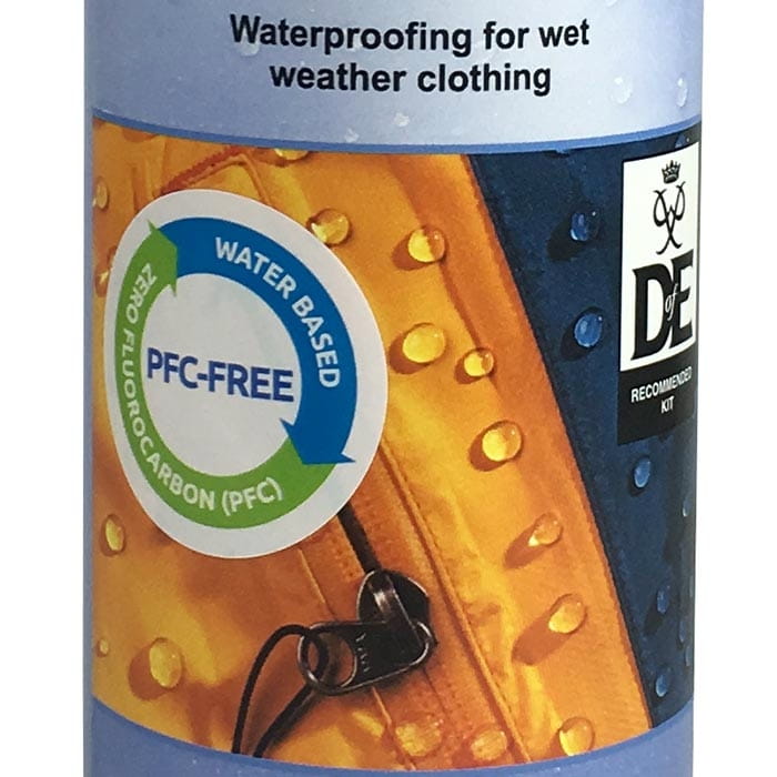 Close-up of Nikwax TX-Direct Wash-In label with PFC-free note and water droplets on yellow and blue background