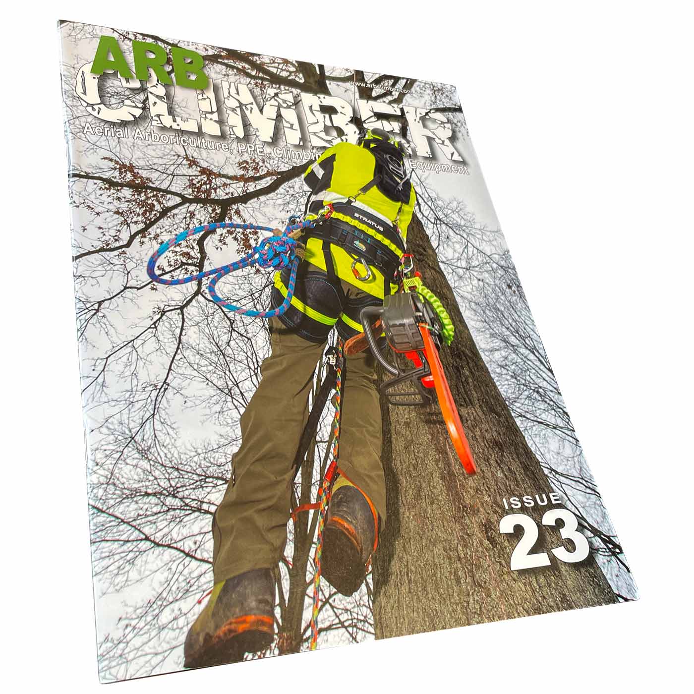 Arb Climber No. 23 magazine with a climber in yellow protective clothing on a tree trunk, chainsaw on the side, title in large letters at the top and issue number 23 at the bottom right, photographed at a slight angle