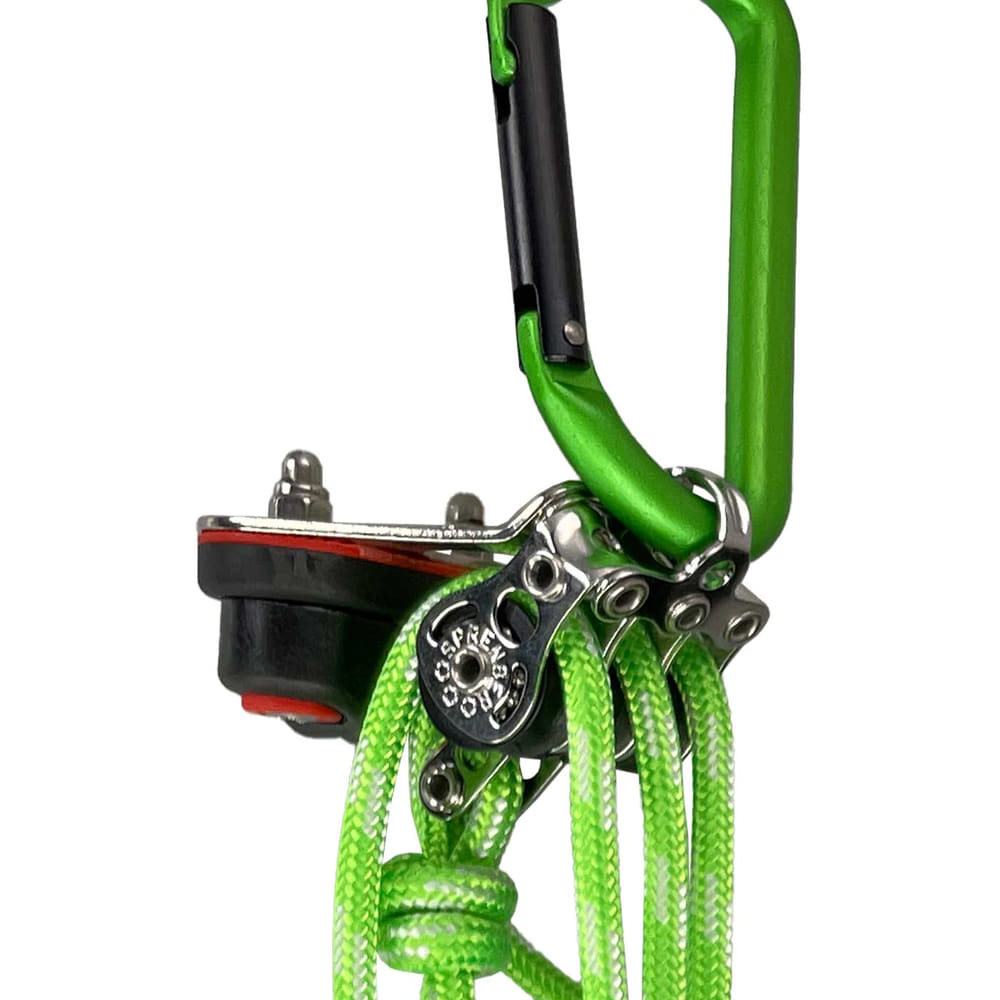 Close-up of green carabiner with metal parts and green ropes of the mini lift of Edelrid