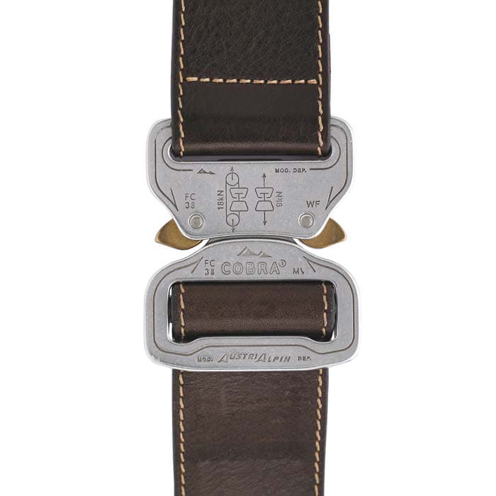 Close-up of the metal clasp of the Cobra 38 leather belt from AustriAlpin with brown leather strap and inscriptions