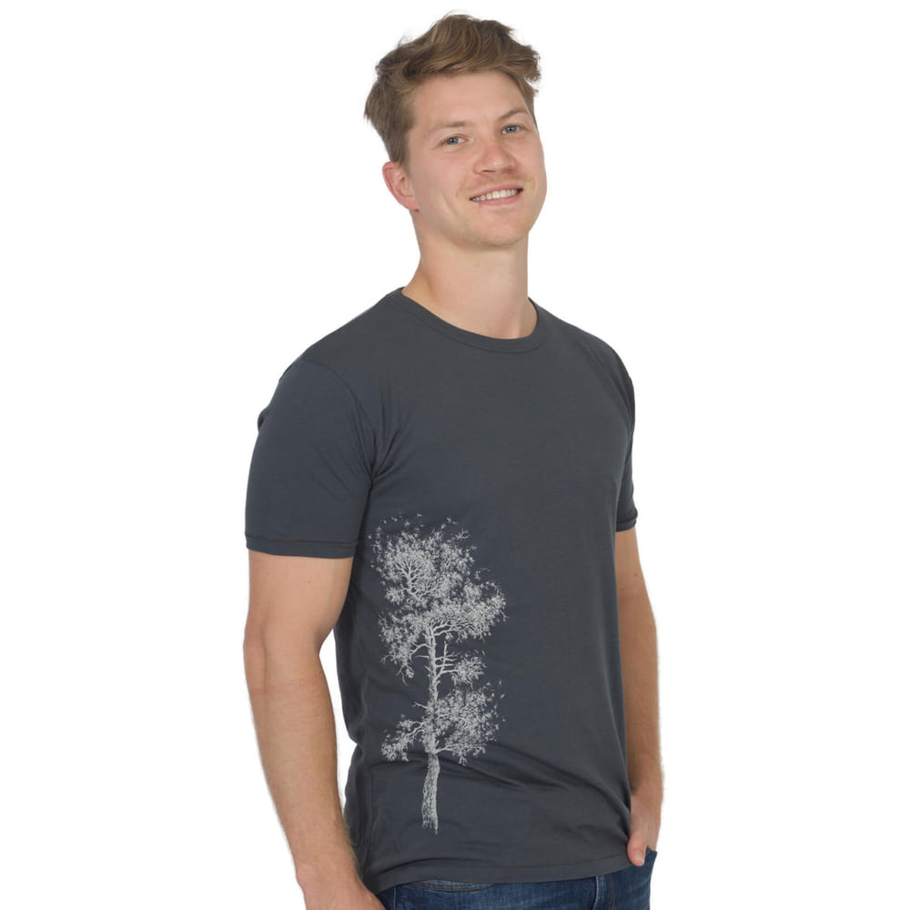 Man wearing a dark gray Pine Tree T-shirt with a white tree print on the left side of the shirt.
