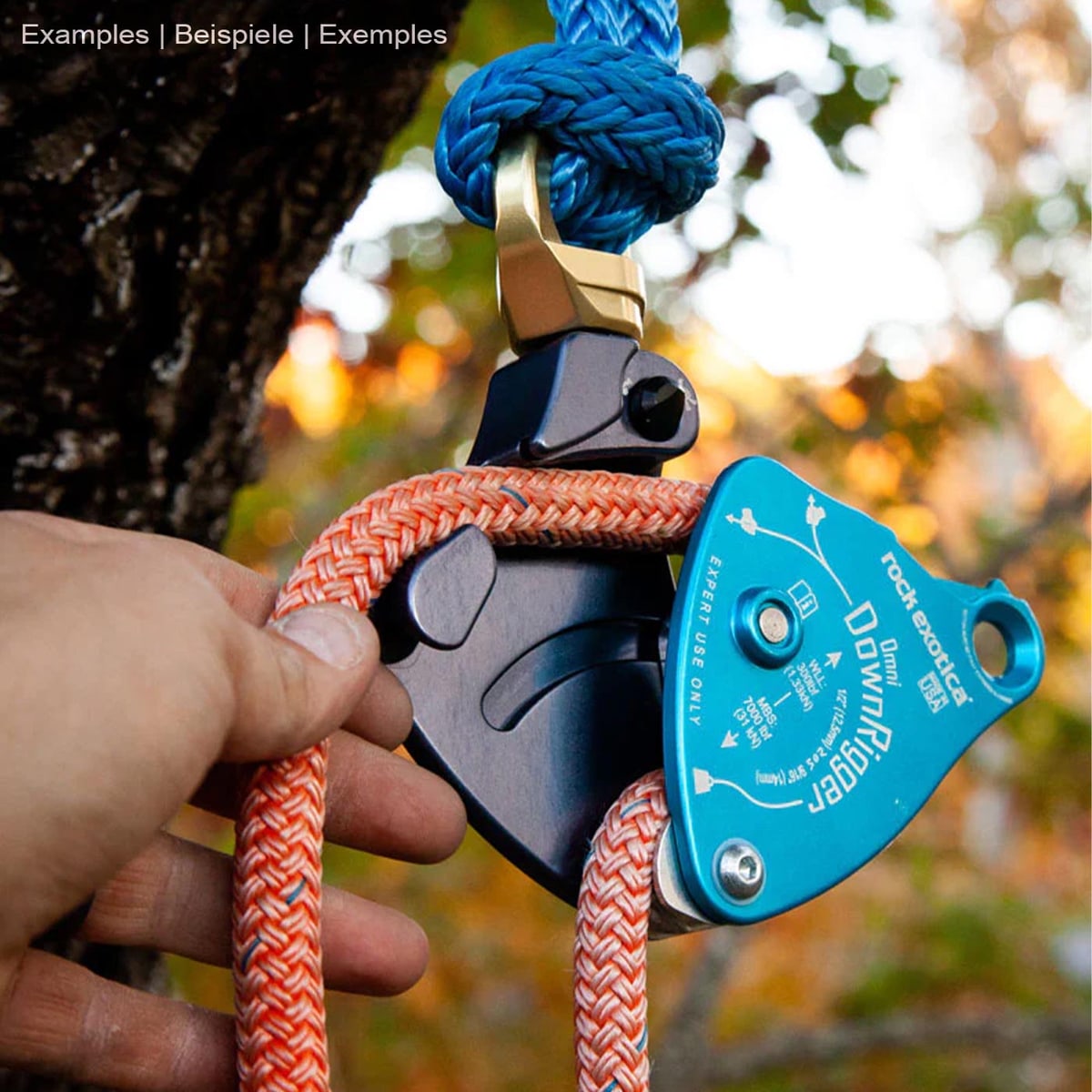Rock Exotica Omni DownRigger in blue with orange rope, one hand holds the rope, manufacturer Rock Exotica, type DownRigger