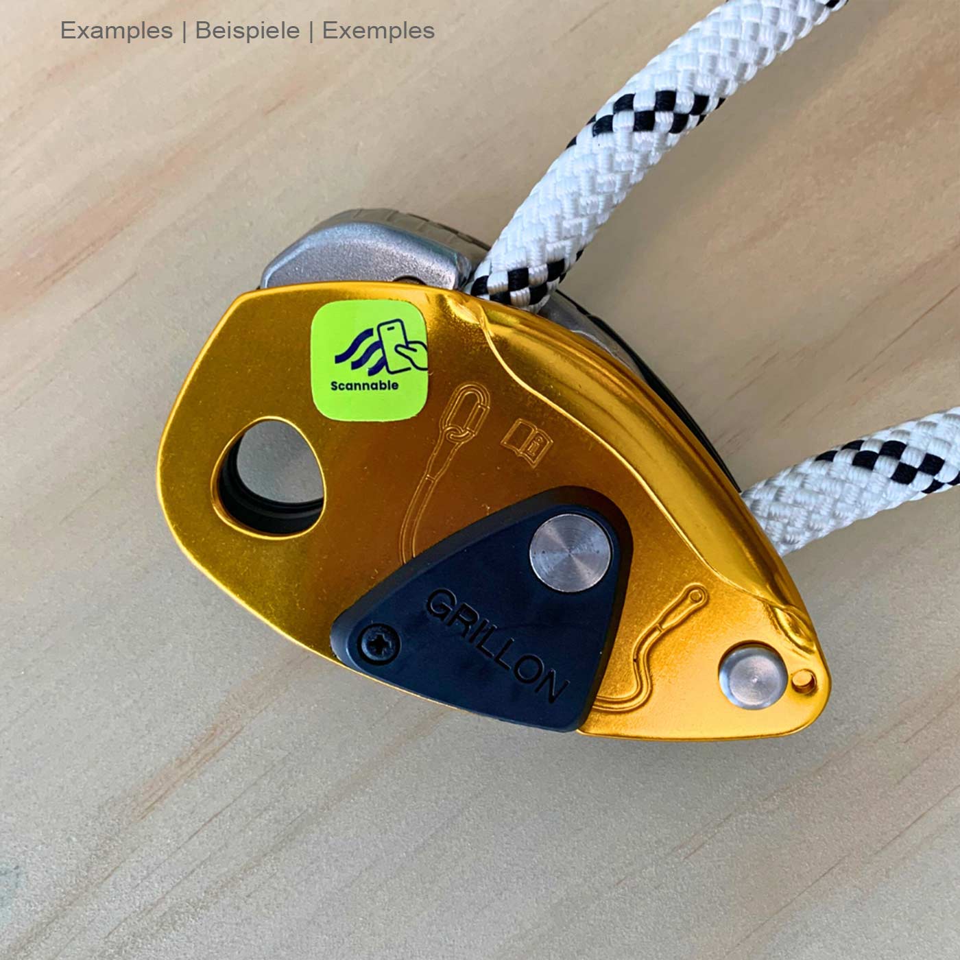 Green On-Metal Sticker NFC Tag by Scannable attached to a gold-colored climbing frame with white and black rope