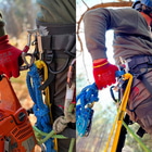 Two pictures side by side with a person in climbing gear, red glove holding blue ropes, carabiner is visible, product name transPorter XL