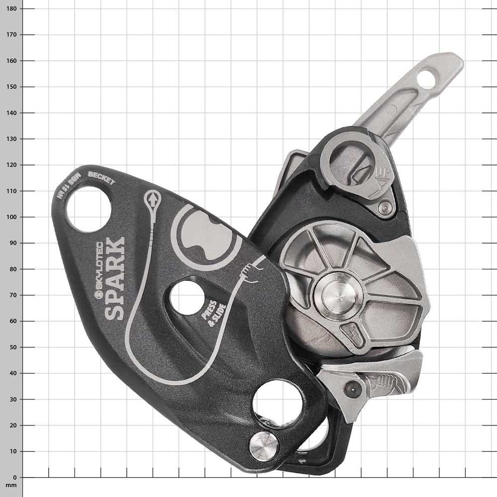 Black device with silver lever, open with visible mechanical parts and imprint "Skylotec Spark"