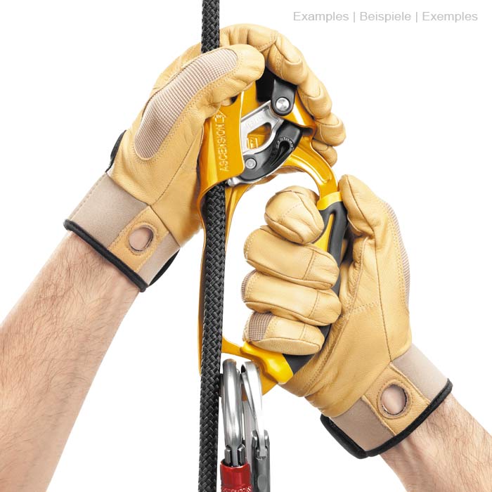 Ascension R in yellow and black with handle, metal parts, rope and carabiner, held by two hands with beige gloves