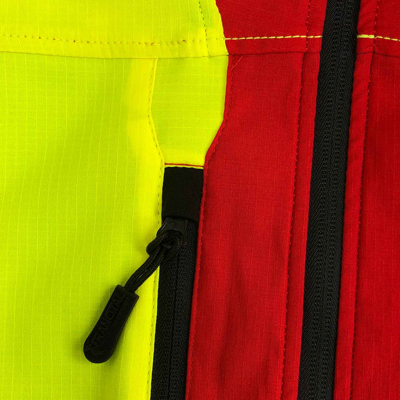 Close-up of the zipper of the Grignan R jacket in red and yellow with black zipper and yellow stitching