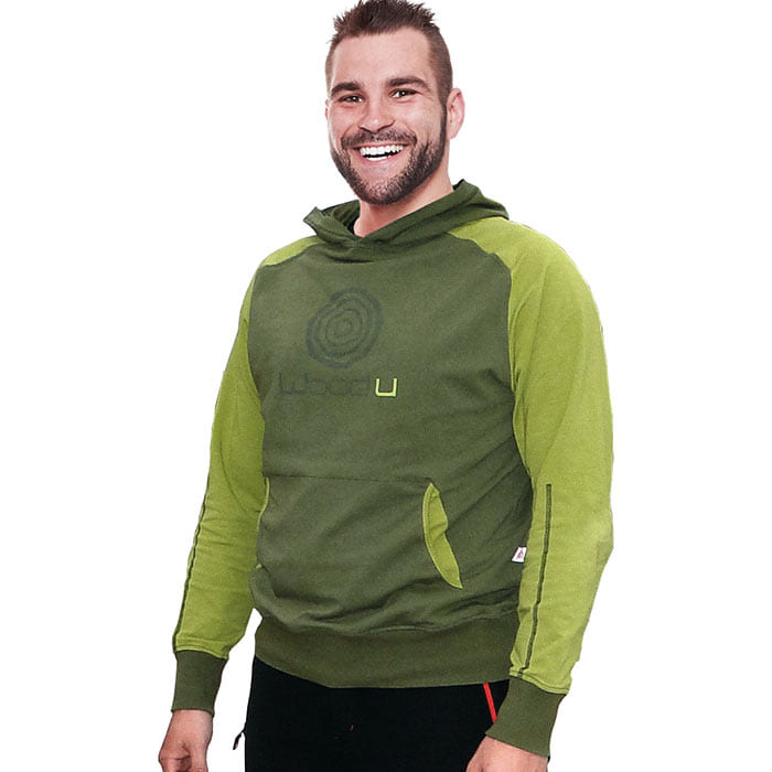 Man wears the Forest WoodU hoodie in two shades of green and smiles