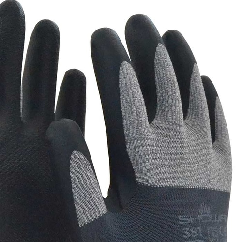 Close-up of the Showa 381 work gloves, focus on the gray fabric back and black fingertips with visible manufacturer name and model number.