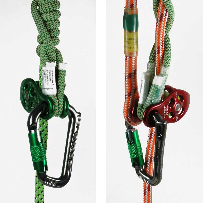 Two climbing ropes with green and red pulleys, each with a Rhino carabiner with a green locking mechanism hanging from it