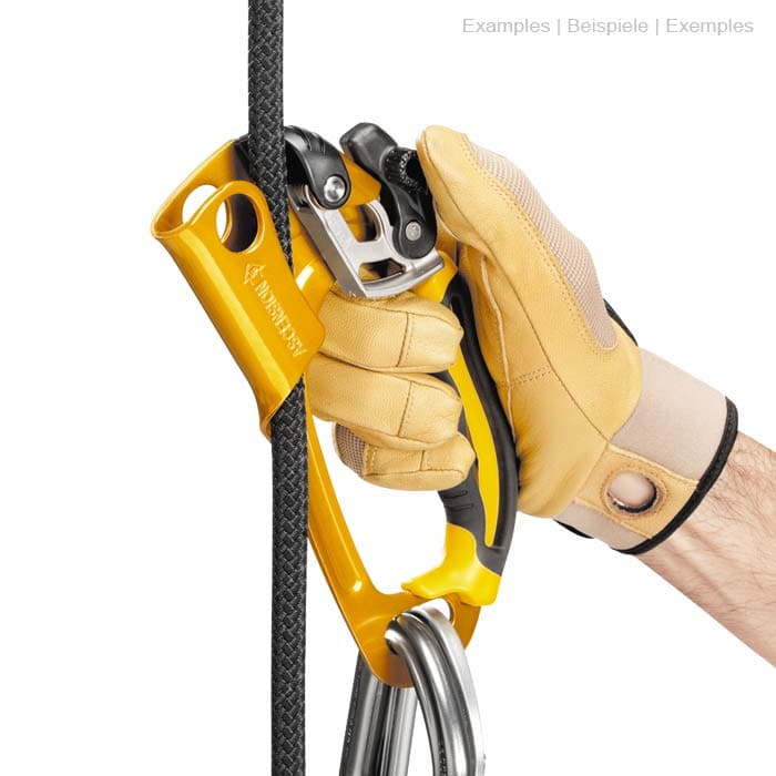 Ascension R in yellow and black with handle, metal parts, rope and carabiner, held by a hand with beige glove in a different position