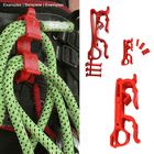 Buddy red plastic clip attached to a green rope hanging from black and red climbing equipment