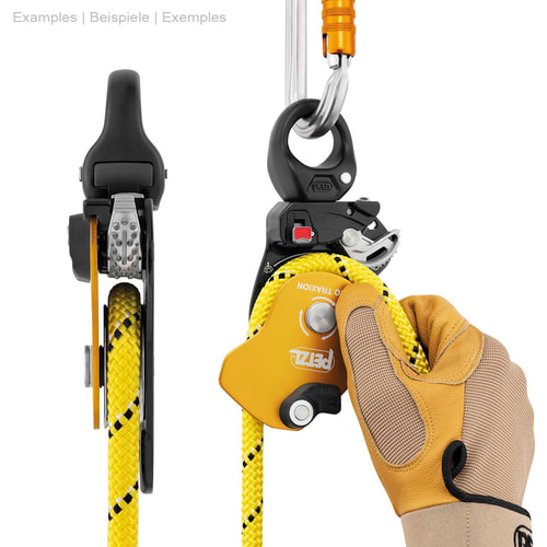Petzl Pro Traxion Rope Pulley in Yellow and Black with Yellow Rope, Held by One Hand with Work Glove, Attached to the Top with a Silver Snap Hook