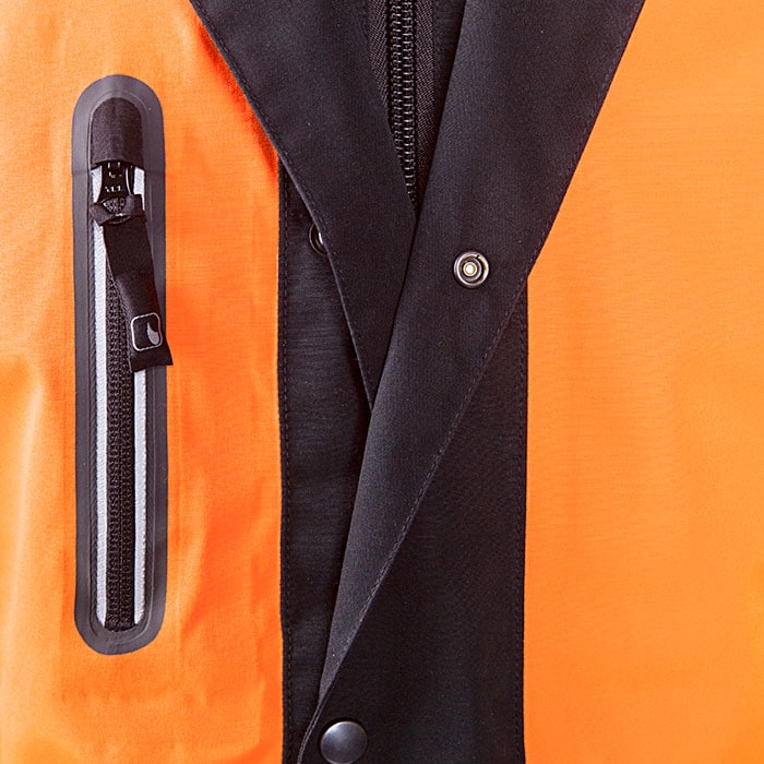 Close-up of the chest pocket with zipper and the black snap button placket of the Keiu rain jacket
